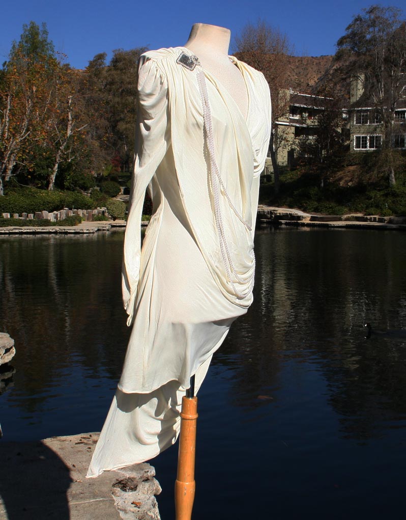 White With Draped Pearls And Shoulder And Hip Brochee